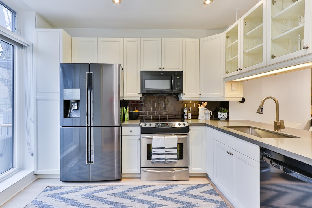 A modern kitchen with various appliances arranged neatly, showcasing a blend of functionality and style.